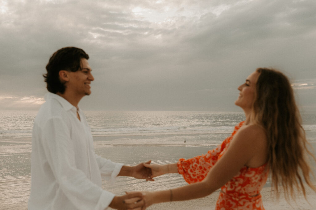 couple dancing at their beach proposal