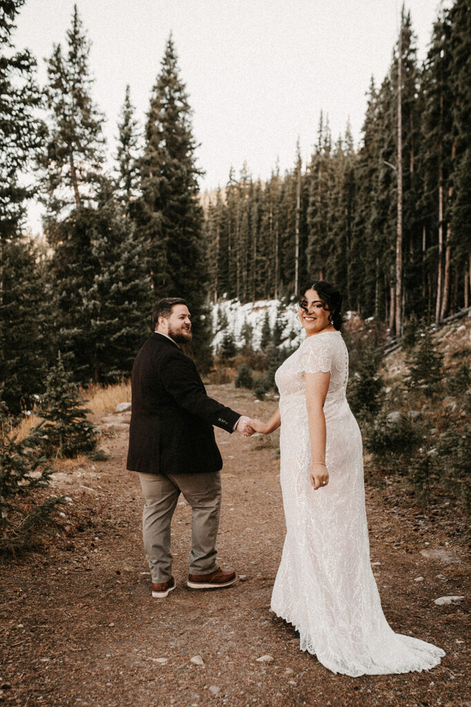 couple walking holding hands during their adventurous elopement in colorado 