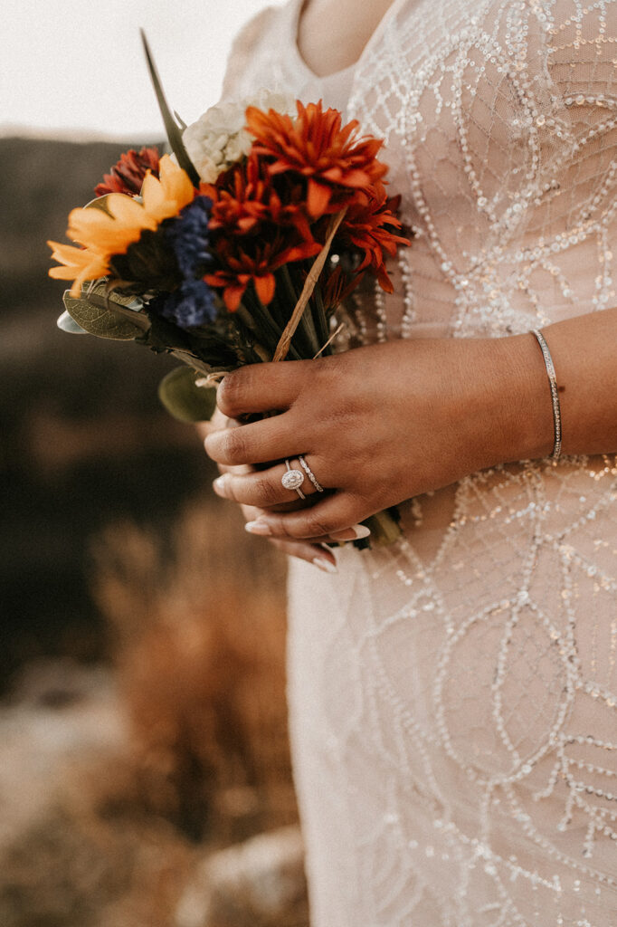 bride holding her colorful bouquet for her adventurous elopement