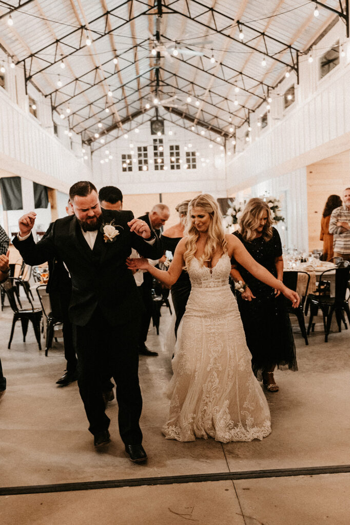 bride and groom dancing with their guests at their boho wedding day