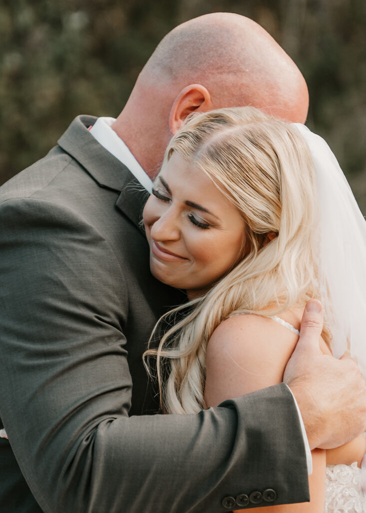 bride and her father hugging after their first look 