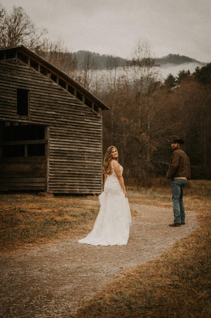 gorgeous couple walking during their wedding nniversary photoshoot at Cade Cove 