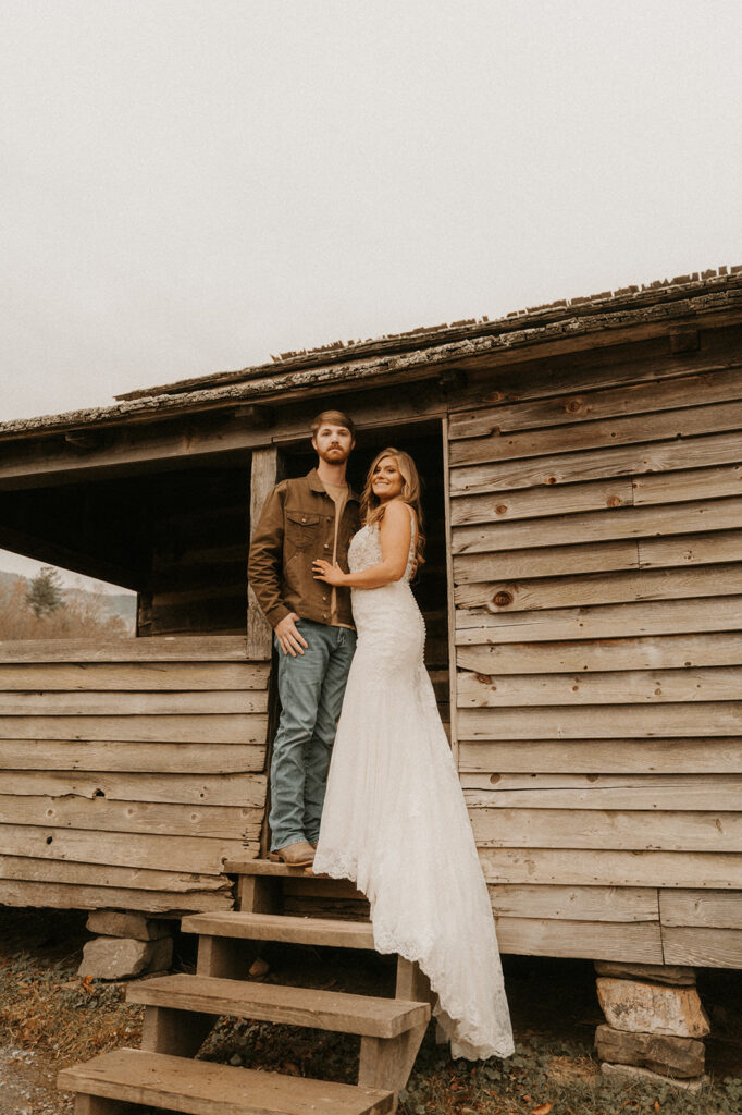 beautiful couple posing in a cabin at Cade Cove 
