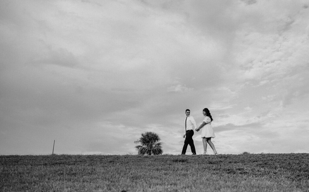 couple walking around the park during their moody engagement session