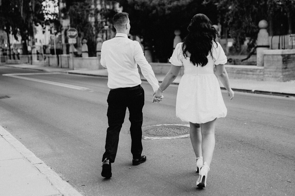 beautiful couple holding hands crossing the streets