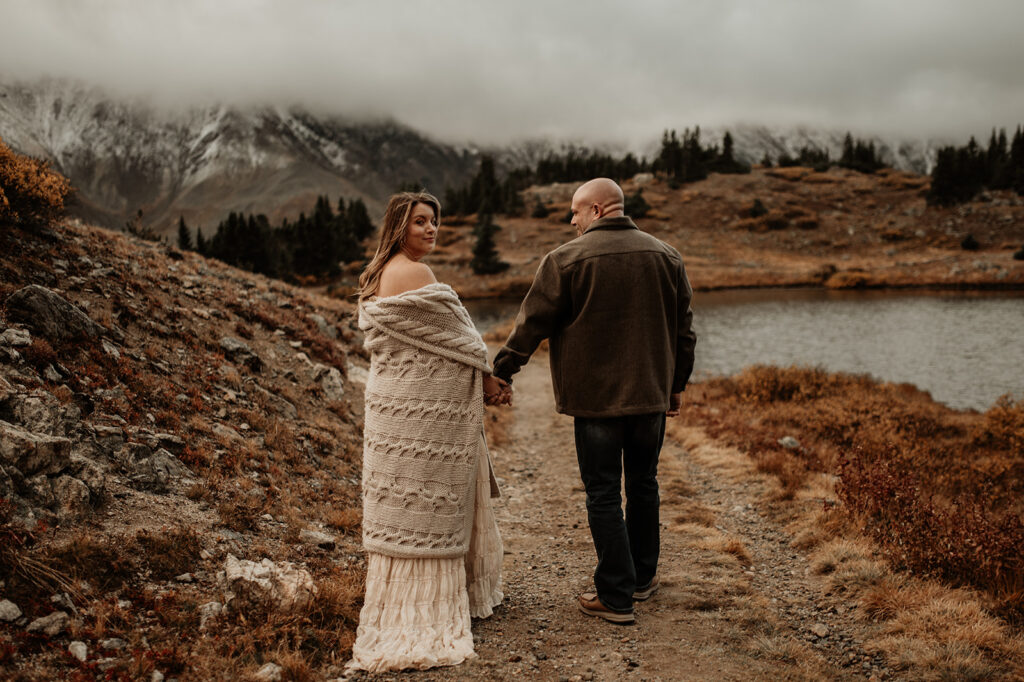couple holding hands walking around loveland pass 