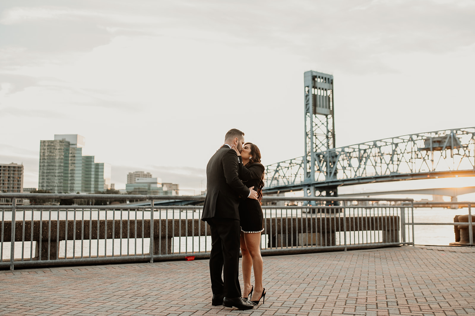 couple kissing at their timeless downtown engagement session
