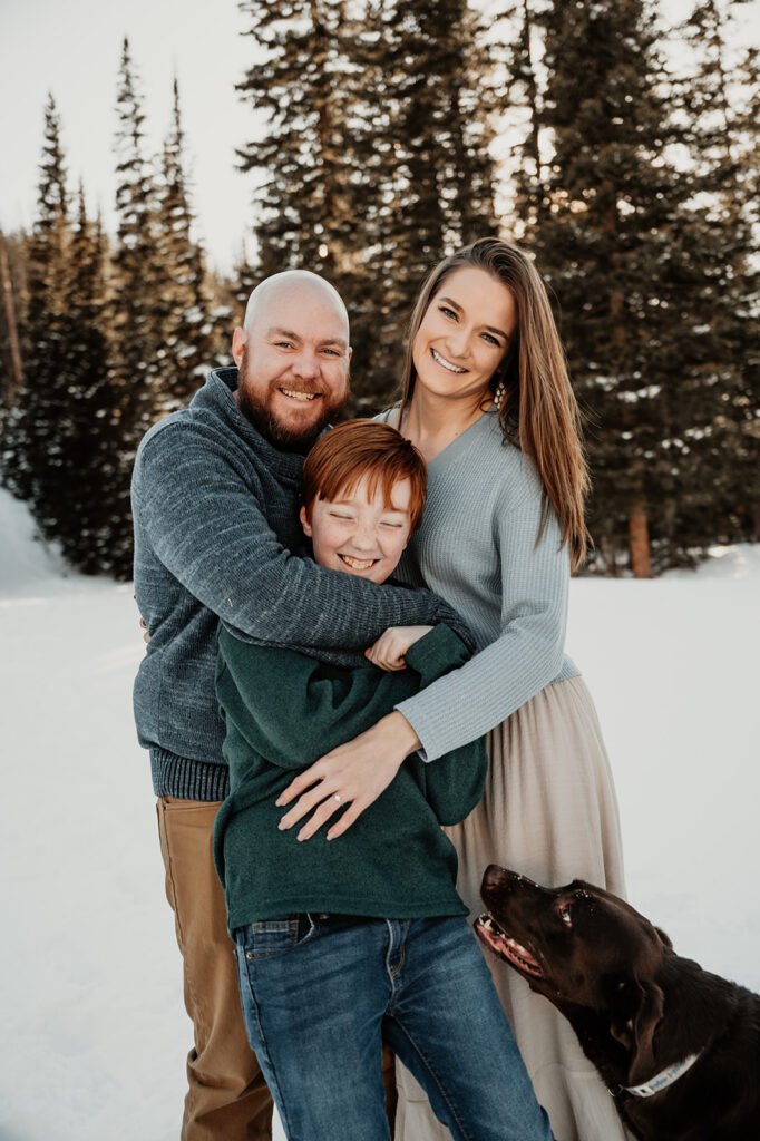 portrait of the couple and their son during their snowy & adventurous engagement session 