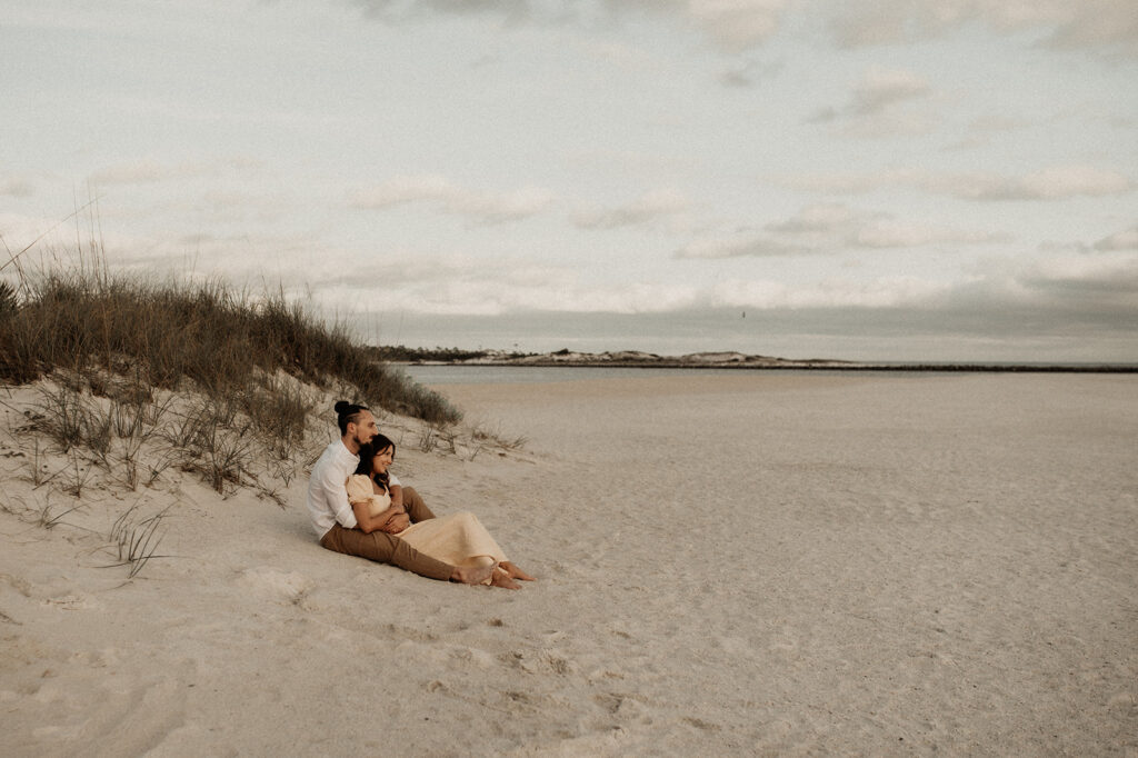 couple hugging sitting at the beach