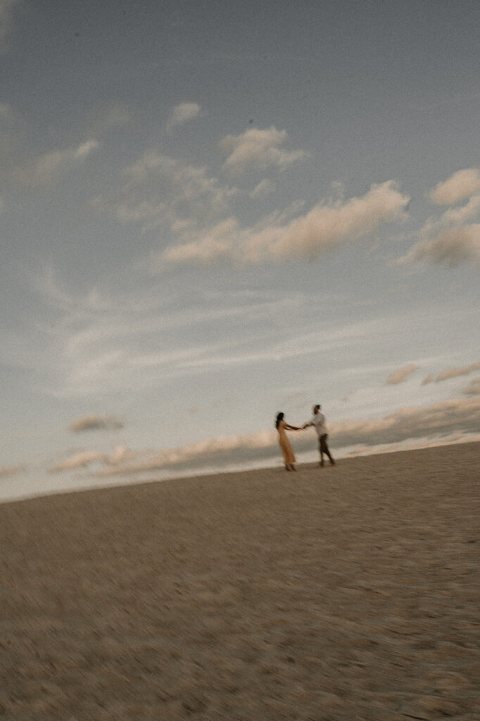 couple running around the beach in florida