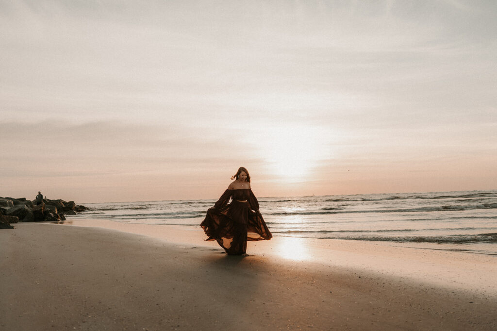 girl running around the beach during her photoshoot