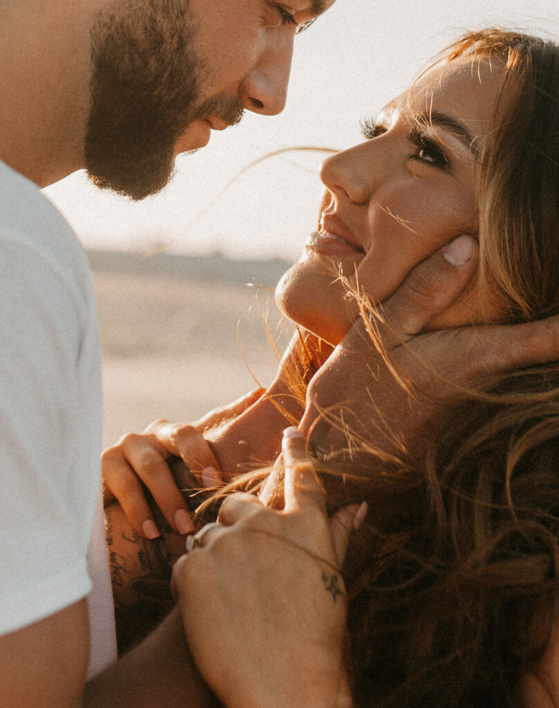 cute couple looking at each other during their maternity session