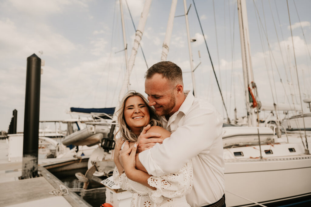 newly engaged couple hugging at their Romantic Beach Engagement Session