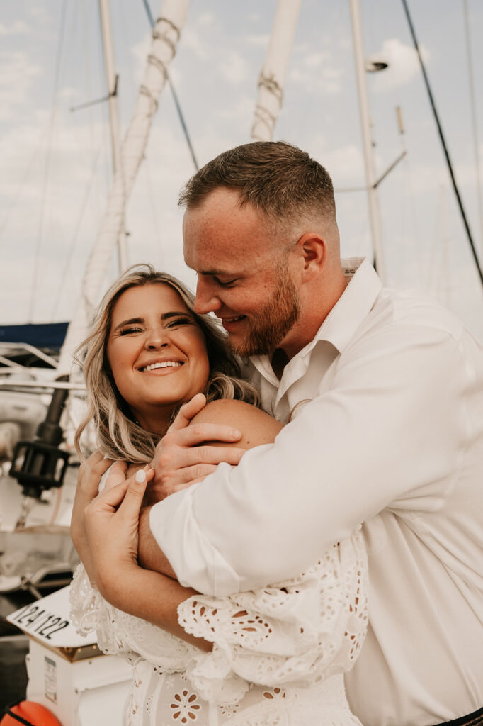 newly engaged couple hugging