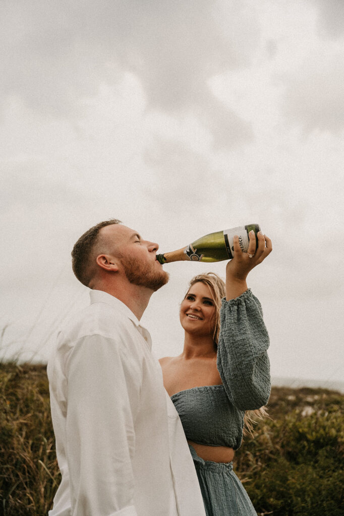 newly engaged couple celebrating with champagne 