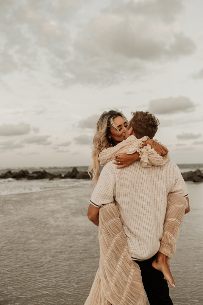 newly engaged couple hugging