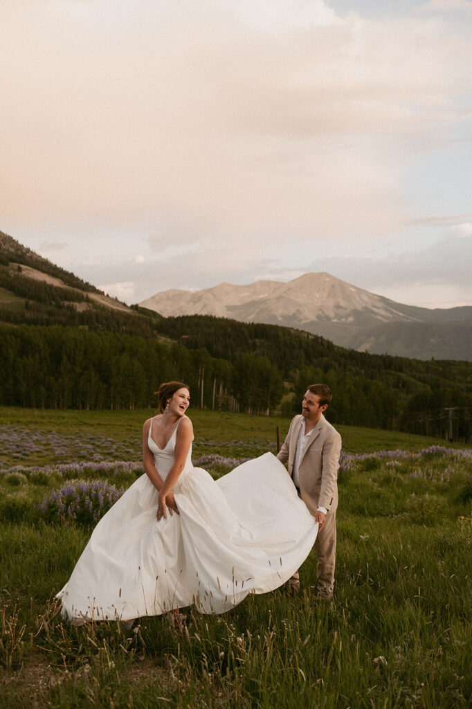 groom helping the bride with her dress - perfect micro wedding venue