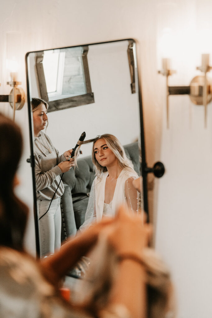 bride getting her hair done for her amazing wedding ceremony