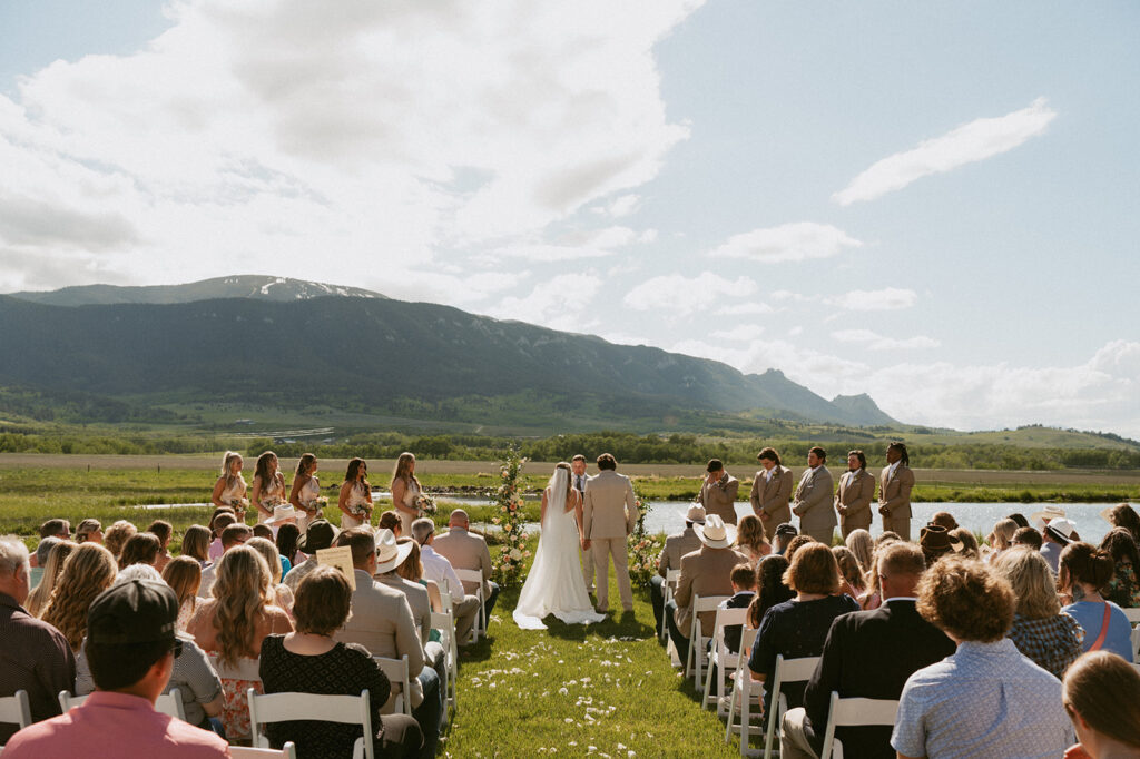 bride and groom holding hands at their wedding ceremony 