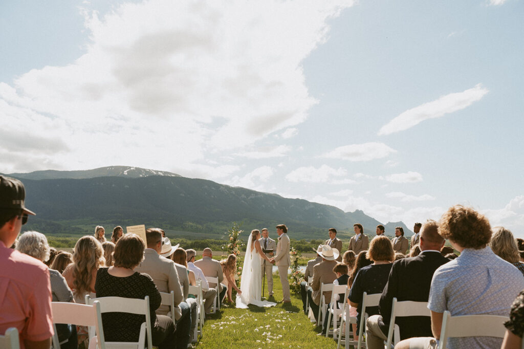 cute couple at their ceremony surrounded by their loved ones