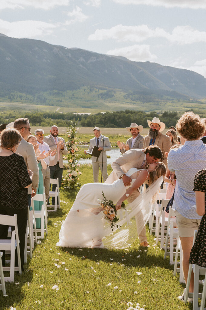 bride and groom kissing at their classy western wedding 