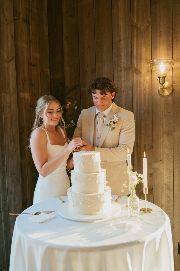 bride and groom cutting their wedding cake at their classy western wedding