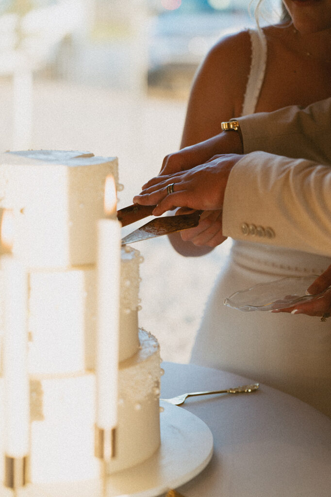 cute couple cutting their wedding cake 