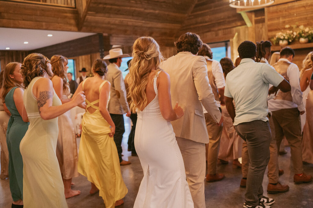 cute couple dancing with their wedding guests at the reception 