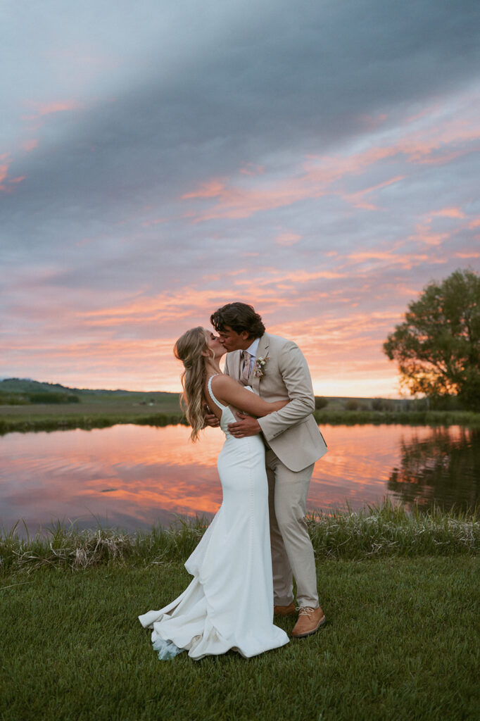 cute picture of the newlyweds kissing at golden hour