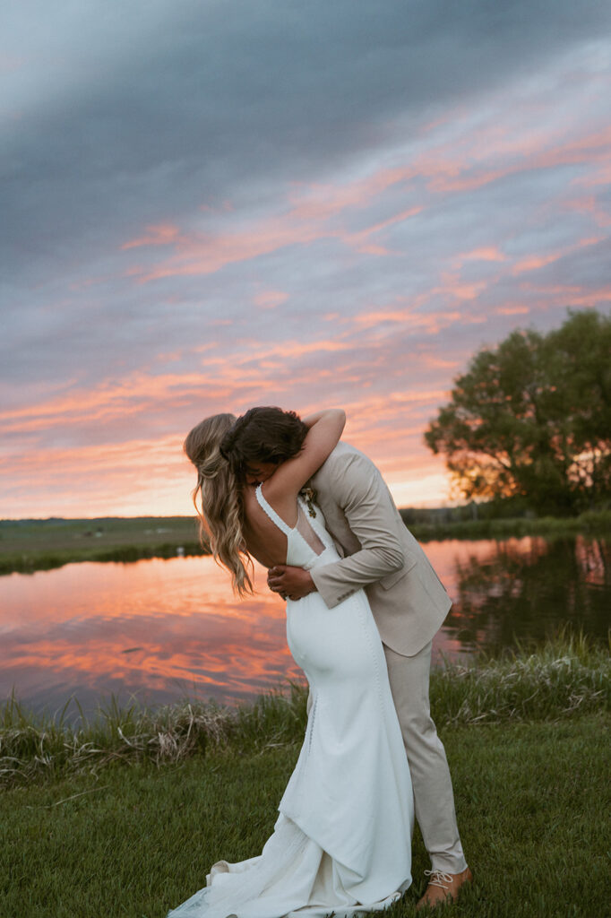 groom kissing the bride on the cheek