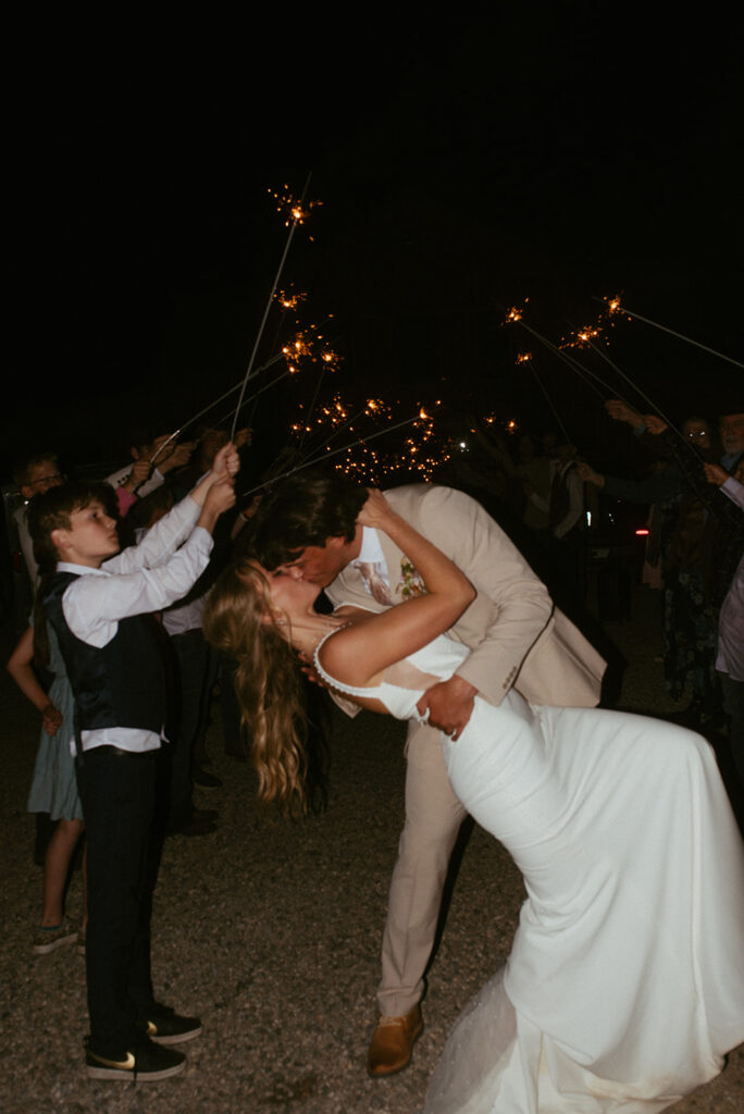 bride and groom kissing after their reception