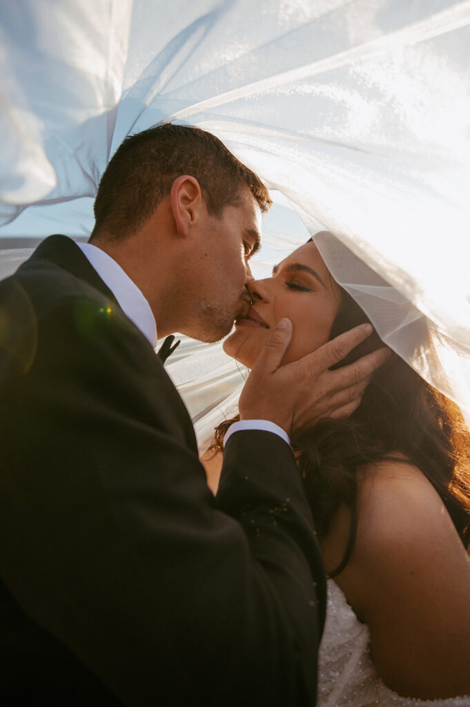 picture of the bride and groom kissing at their bridal portraits 