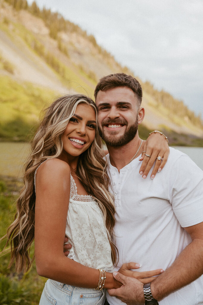 cute couple looking at the camera during their photoshoot 