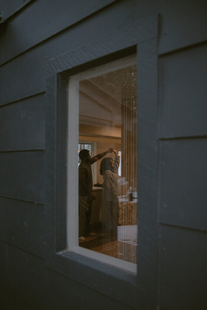 couple dancing in the kitchen during their photoshoot