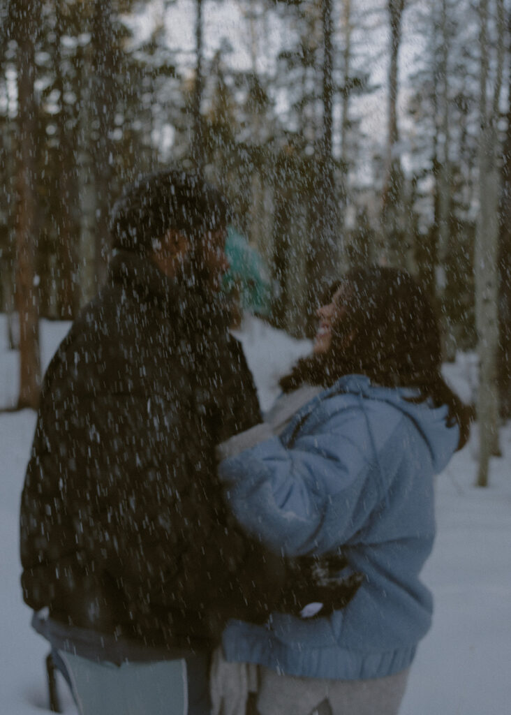 cute couple smiling at each other during their photoshoot 