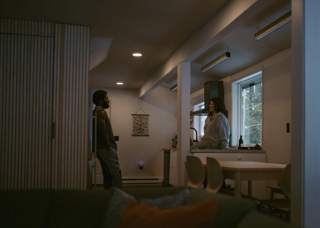 cute couple looking at each other during their cozy couple session in colorado