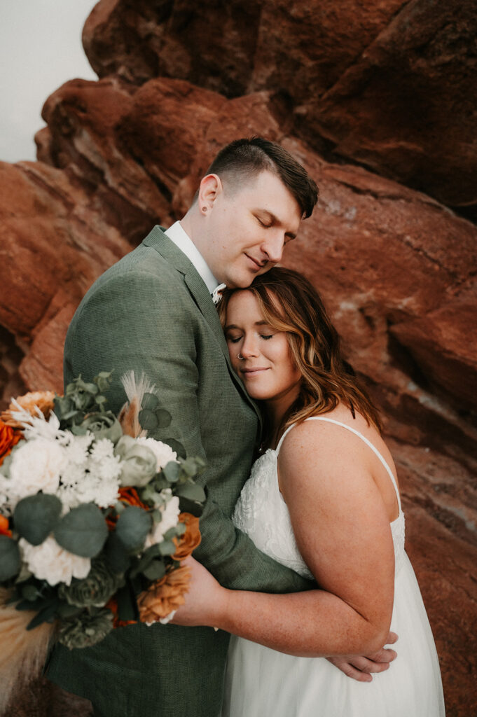 picture of the bride and groom hugging 