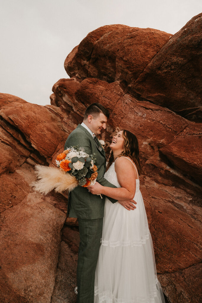 cute portrait of the bride and groom laughing with each other