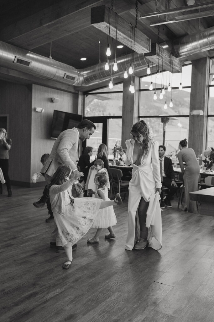 cute couple dancing with their children at their elopement reception