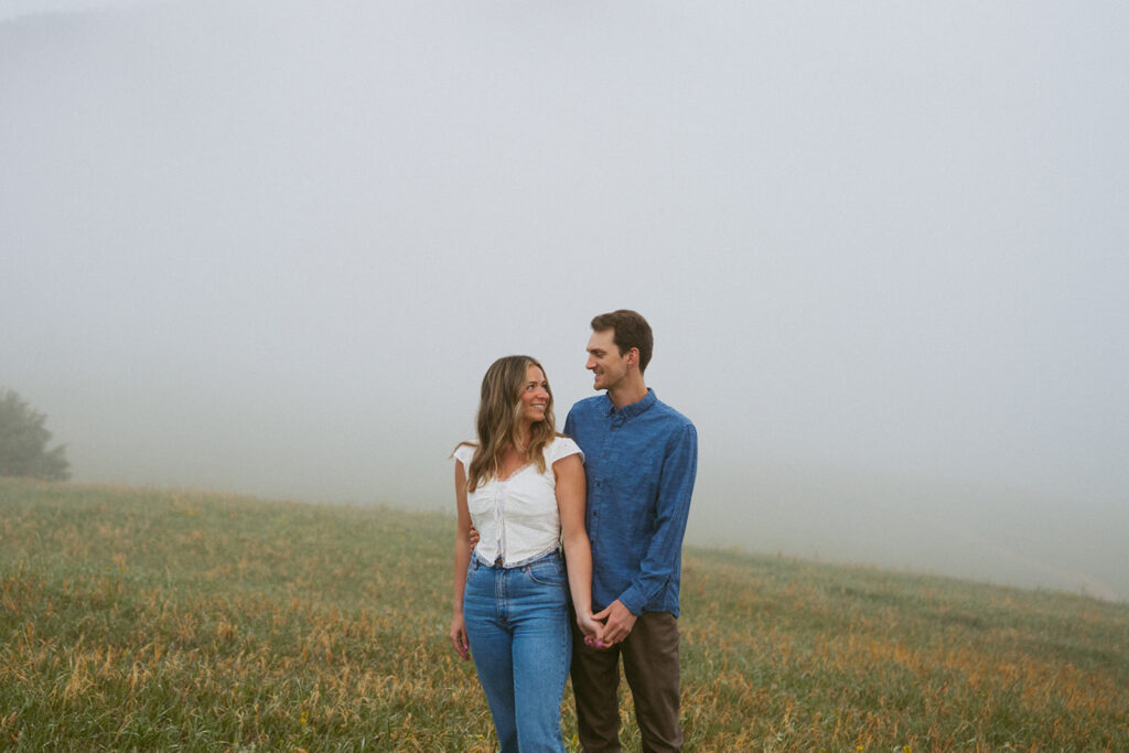 cute picture of the newly engaged couple smiling at each other