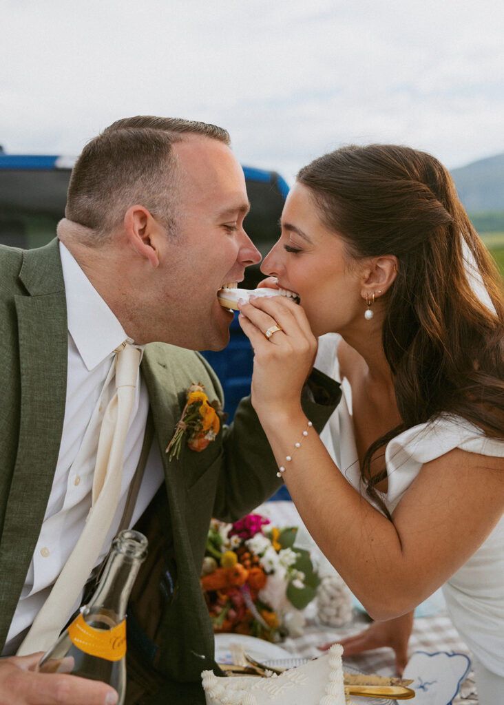 cute couple trying their wedding cake
