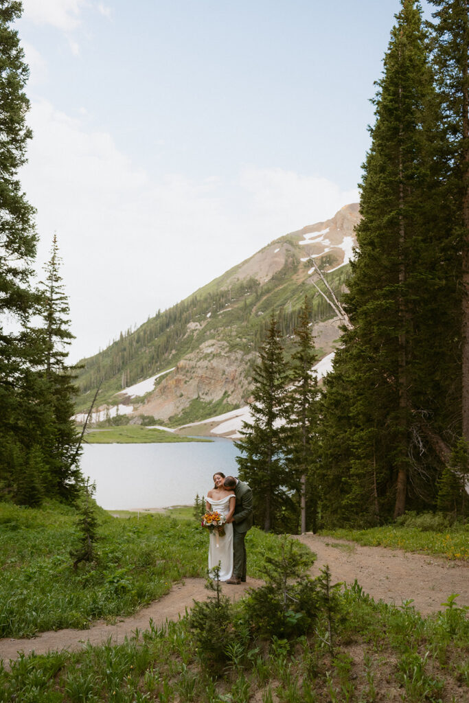 groom kissing the bride on the neck