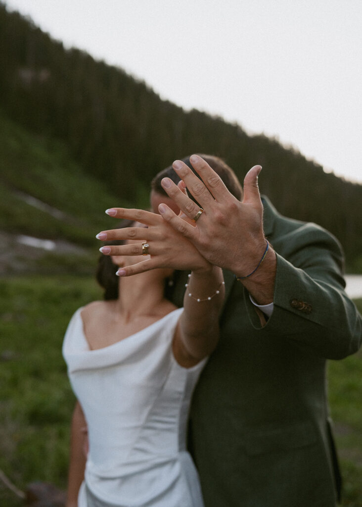 cute picture of the newlyweds showing their wedding rings