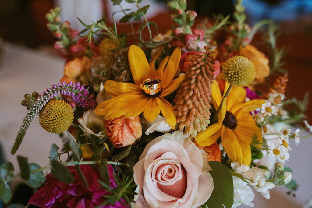 stunning picture of the elopement bouquet and the wedding rings
