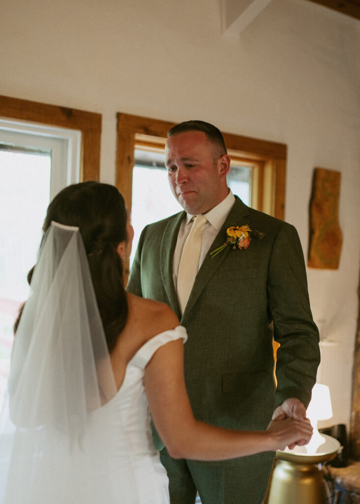 picture of the groom emotional seeing the bride in her wedding dress for the first time