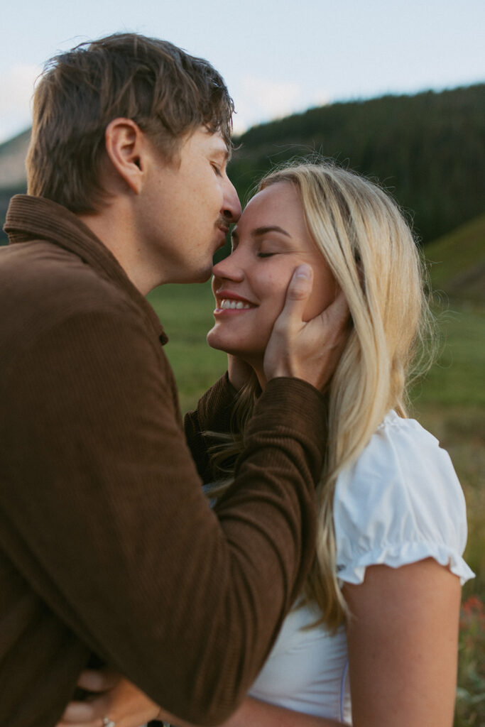 fiance kissing his fiance on the forehead 