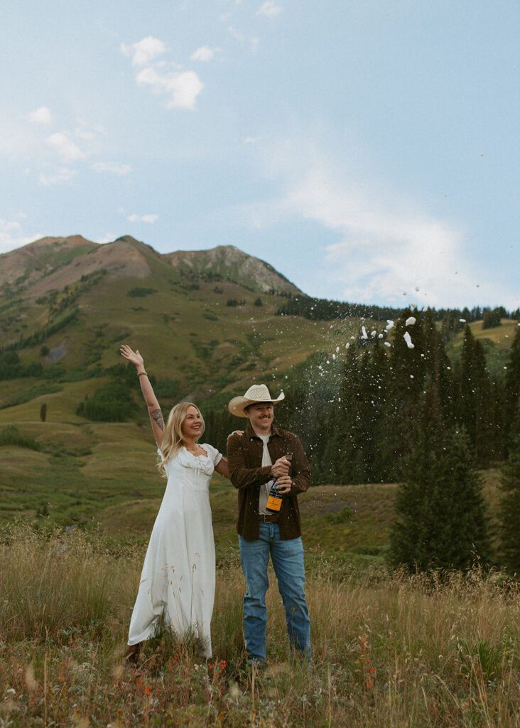 cute couple celebrating their engagement with champagne