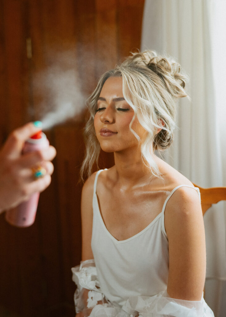 bride getting her makeup done for her wedding day