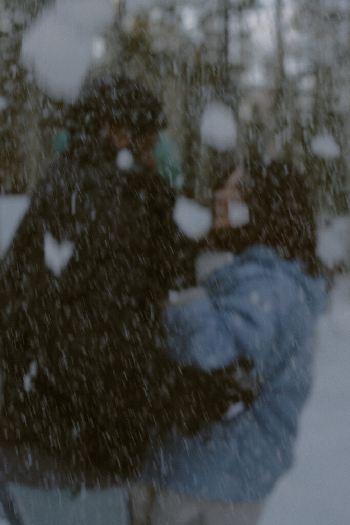 couple playing in the snow during their session
