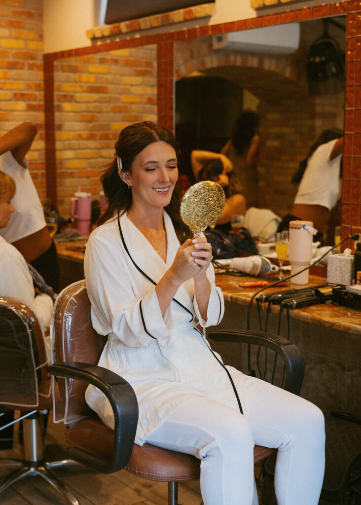 bride getting her makeup done for her ceremony